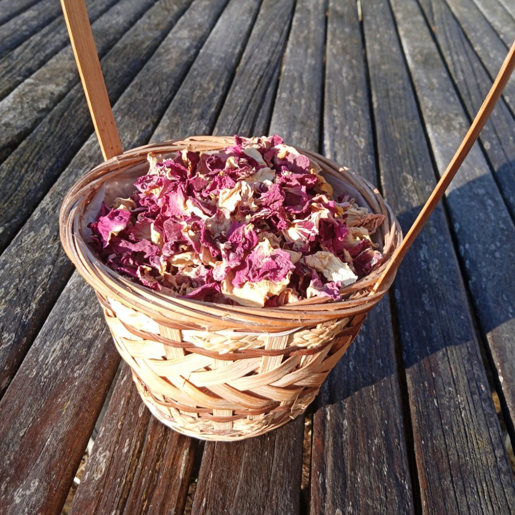 Basket of dried flowers on a wooden deck